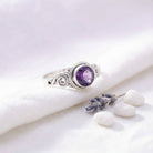 [KI] Silberring mit Amethyst auf hellem Stoff