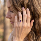 [KI] Frau trägt Silberring mit Amethyst an der Hand am Haar