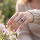 [KI] Granatring aus Silber getragen an der Hand im Freien