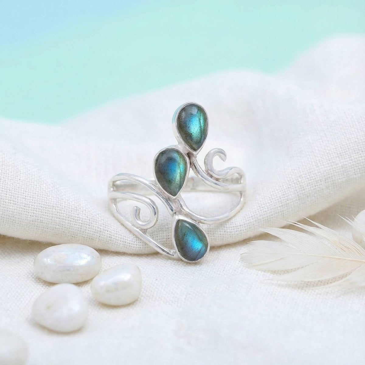 Silberring mit Labradorit auf hellem Stoff
