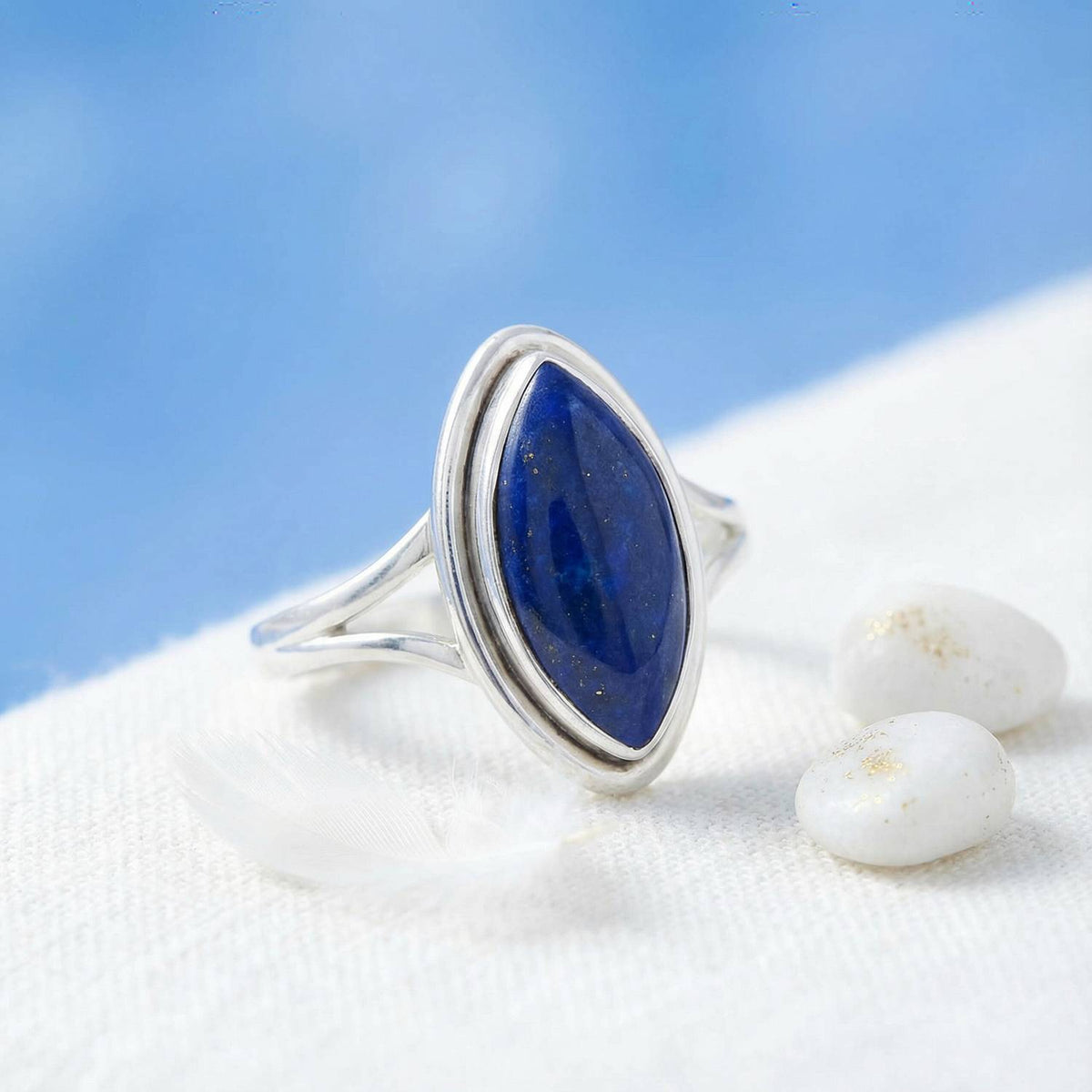 Silberring mit Lapislazuli auf hellem Stoff