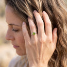 [KI] Frau trägt Silberring mit Peridot an der Hand am Haar