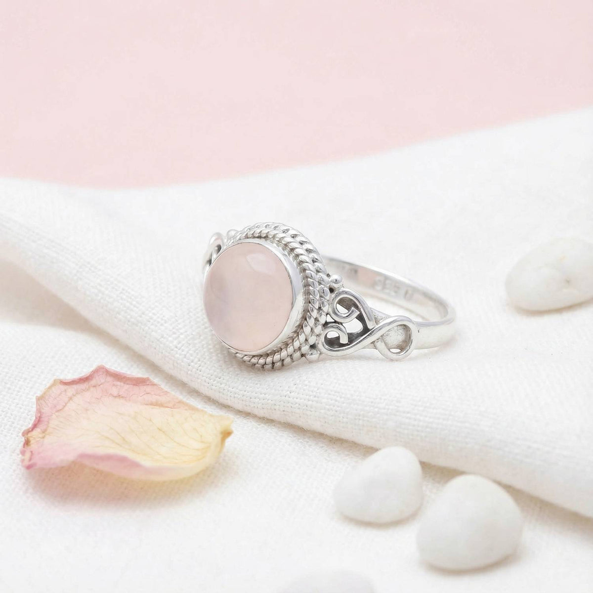 Silberring mit Rosenquarz auf hellem Stoff