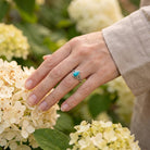 [KI] Silberring mit Türkis an der Hand zwischen Blumen