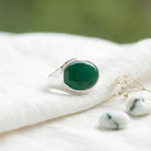 [KI] Silberring mit grüner Onyx auf hellem Stoff